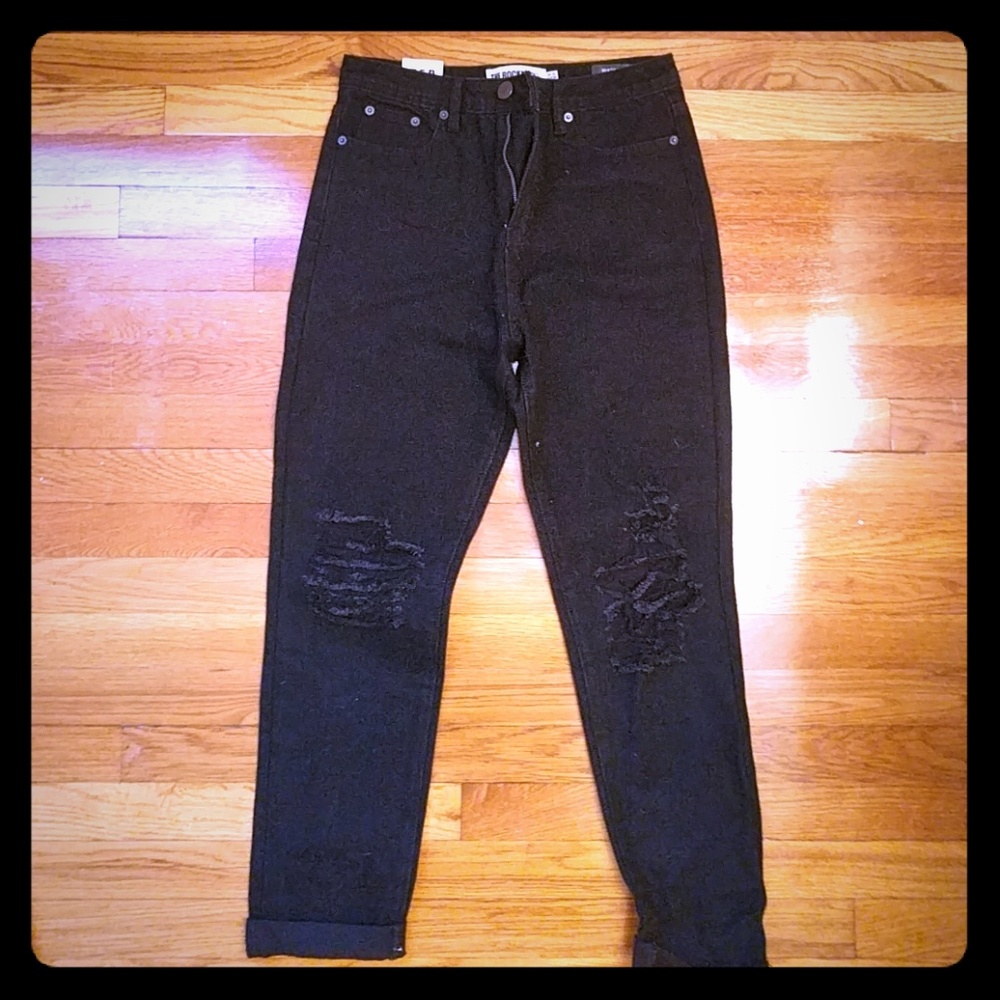 Black jeans with a rip in the knee
